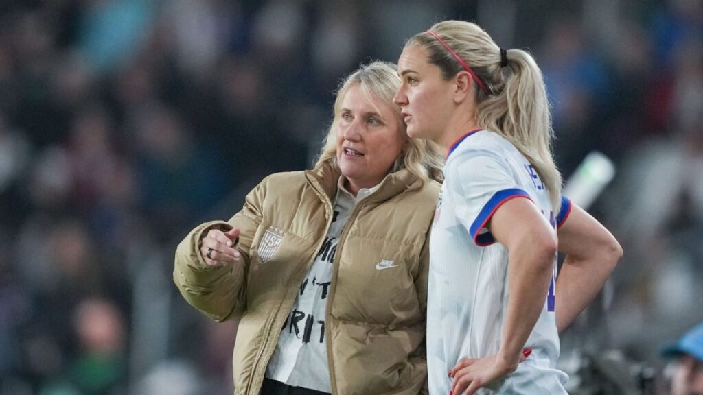 USWNT head coach Emma Hayes standing on the touchline looking thoughtful during an international football match