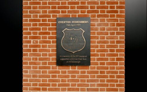 Statue of two young mascots holding hands in Everton and Liverpool shirts at Hill Dickinson Stadium