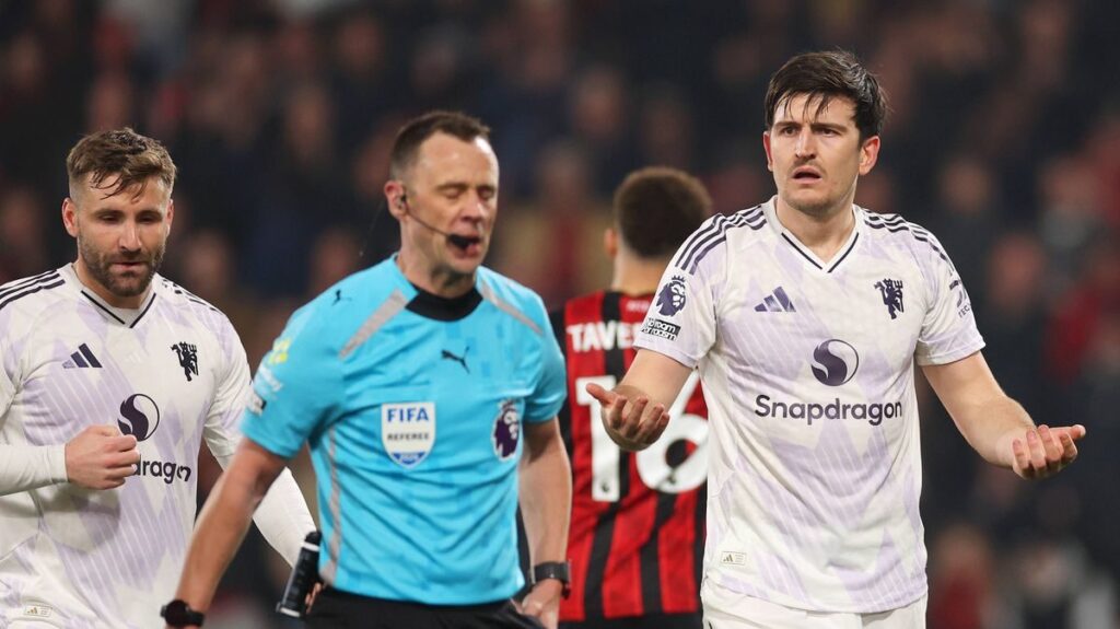 Harry Maguire reacting to the referee after receiving a red card during a match against Bournemouth