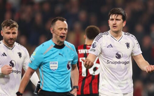 Harry Maguire reacting to the referee after receiving a red card during a match against Bournemouth