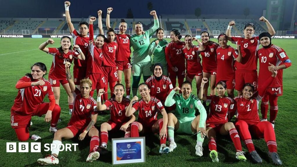 Afghanistan women's football team players standing together on the pitch