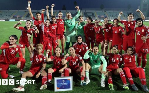 Afghanistan women's football team players standing together on the pitch
