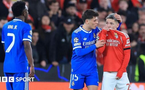 Referee showing a red card to a football player on the pitch