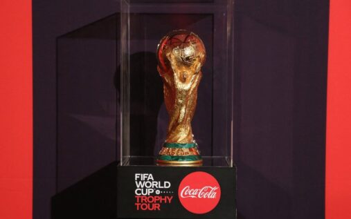 A generic view of a football referee holding a whistle and disciplinary cards