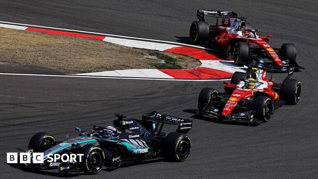 Formula 1 cars racing closely on track demonstrating the new hybrid engine regulations