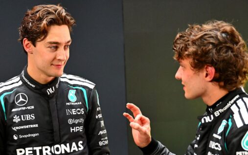George Russell in Mercedes team gear speaking in the Formula 1 paddock
