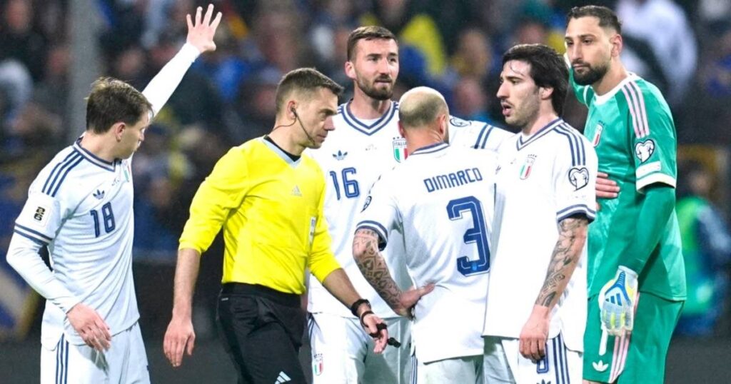 Dejected Italian national football team players walking off the pitch