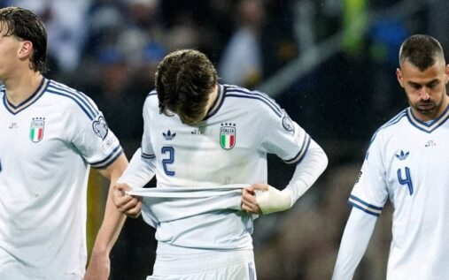 Dejected Italy national team players on the pitch following their play-off defeat