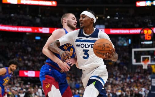 Jaden McDaniels of the Minnesota Timberwolves handling the basketball on the court