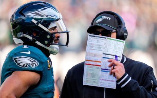 Jalen Hurts looking dejected on the field in his Philadelphia Eagles uniform during a playoff game