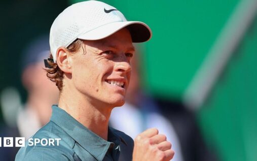 Jannik Sinner hitting a forehand on the clay courts at the Monte Carlo Masters