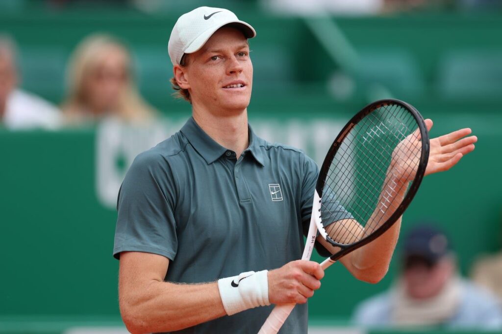 Jannik Sinner hitting a forehand on a clay court at the Monte Carlo Masters