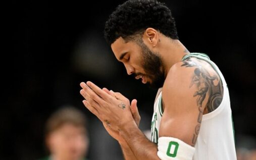 Boston Celtics forward Jayson Tatum dribbling the ball on the court during an NBA game