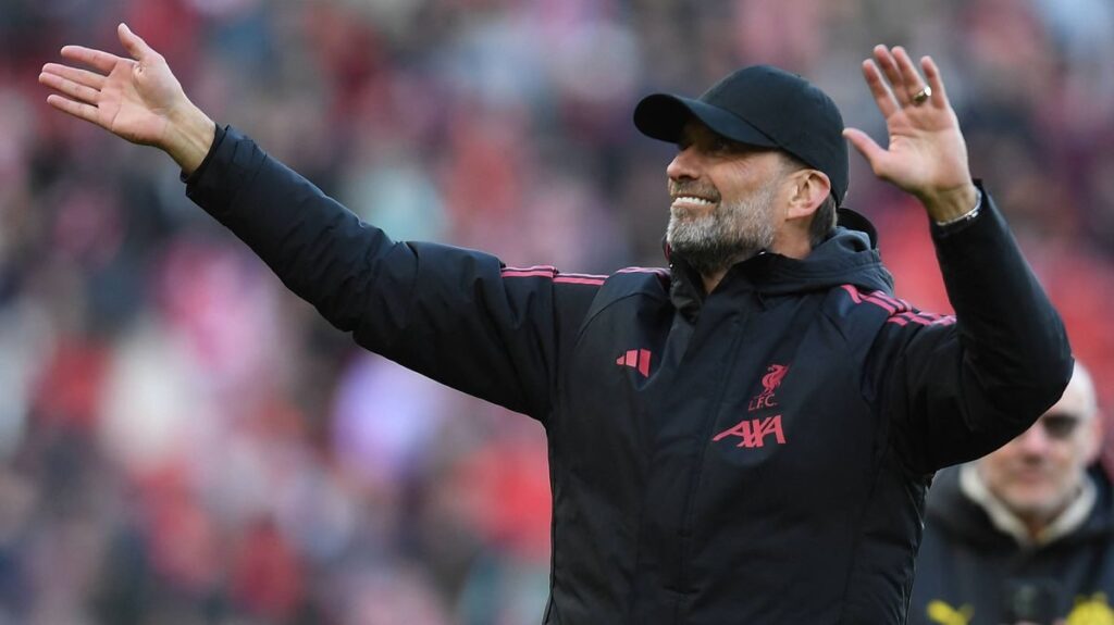 Jurgen Klopp smiling on the pitch during the Liverpool Legends charity match at Anfield.
