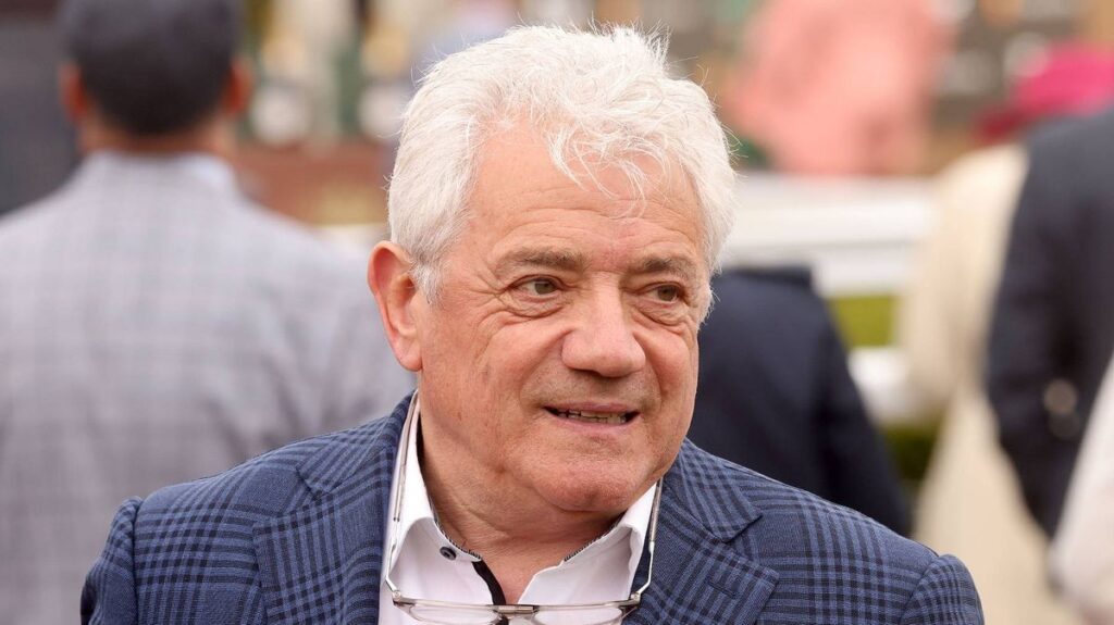 Kevin Keegan smiling and waving to supporters during his time as manager of Newcastle United