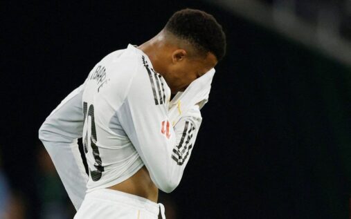 Kylian Mbappe looking dejected on the pitch after sustaining an injury