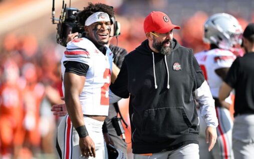 Indiana quarterback Fernando Mendoza preparing to throw a pass during a college football game.