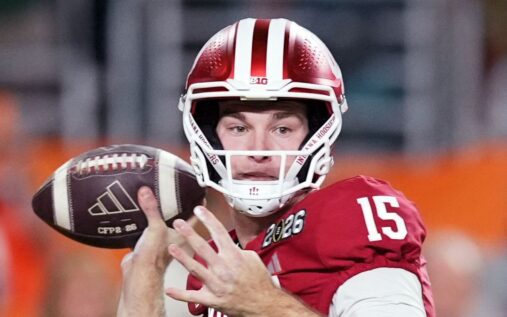 Fernando Mendoza preparing to throw a pass during a college football game