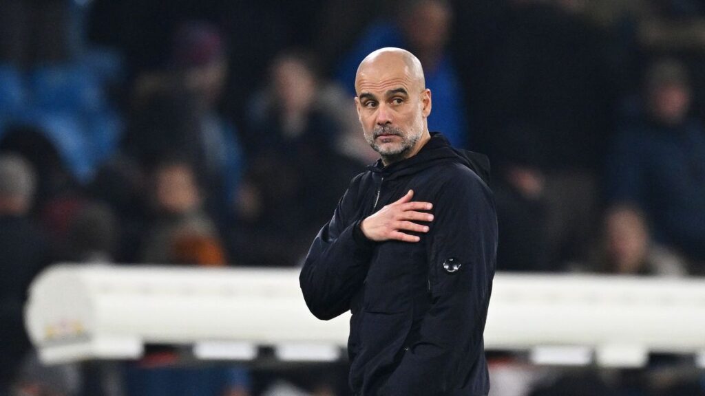 Pep Guardiola gesturing on the touchline during a Manchester City match