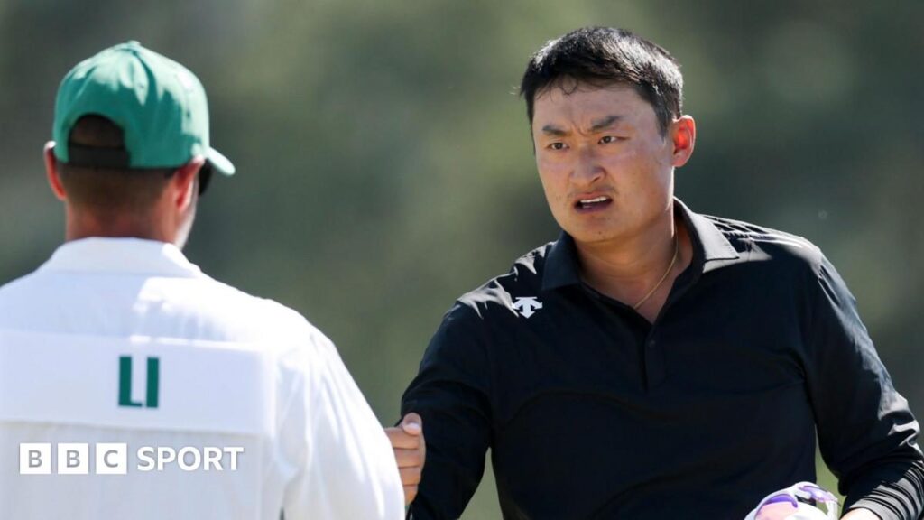 Golfer Li Haotong playing a shot on the fairway during the Masters tournament at Augusta National