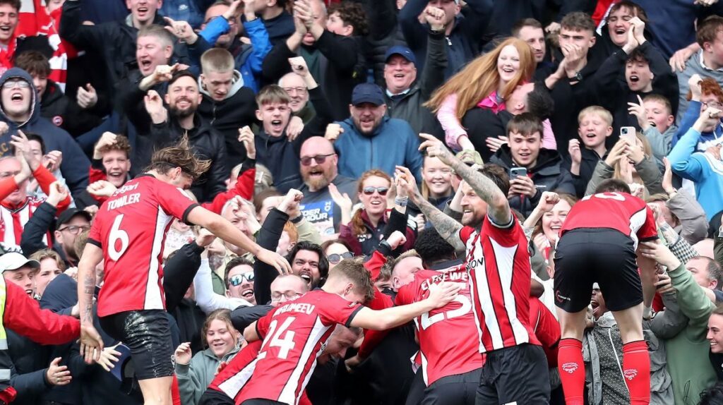 Lincoln City players celebrating their promotion to the Championship