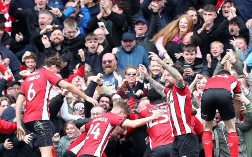 Lincoln City players celebrating their promotion to the Championship