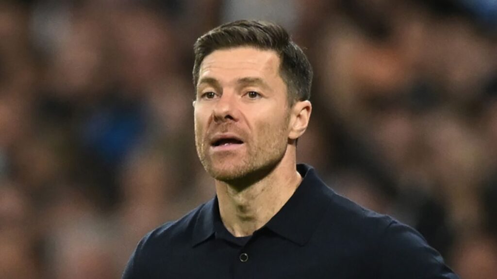 Liverpool manager Arne Slot looking thoughtful on the touchline during a Premier League match