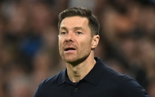 Liverpool manager Arne Slot looking thoughtful on the touchline during a Premier League match