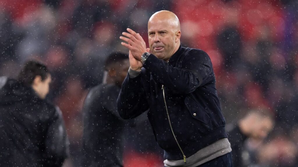 Liverpool manager Arne Slot looking thoughtful on the touchline