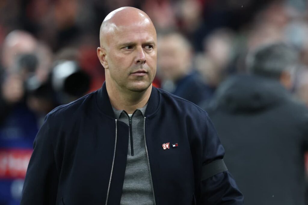Liverpool manager Arne Slot looking thoughtful on the touchline during a Premier League match