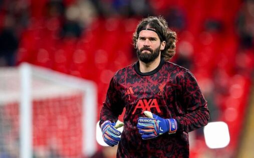 Liverpool goalkeeper Alisson Becker looking dejected on the pitch during a match