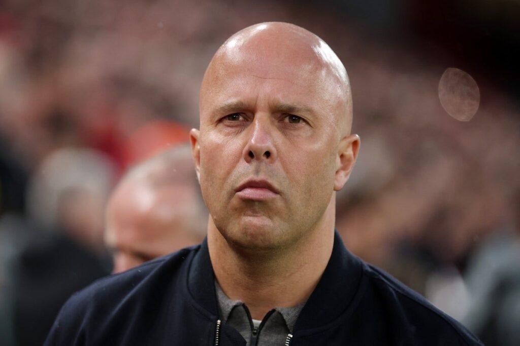 Liverpool manager Arne Slot looking thoughtful on the touchline during a match