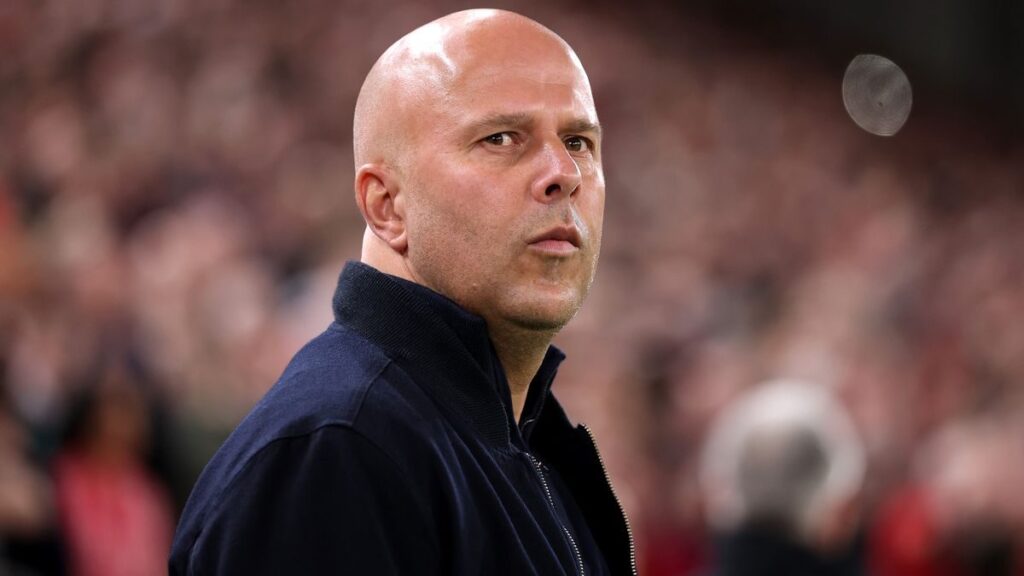 Liverpool manager Arne Slot looking thoughtful on the touchline