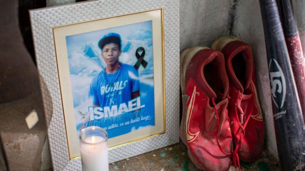 Baseball cleats and wooden bats resting on a porch in the Dominican Republic