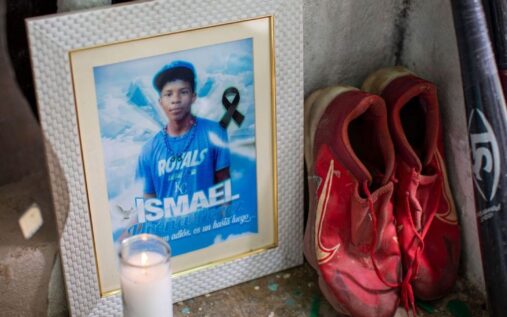 Baseball cleats and wooden bats resting on a porch in the Dominican Republic