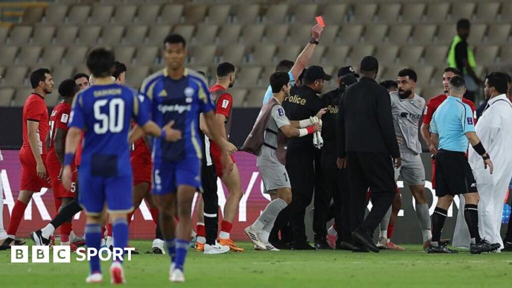 Referee Shaun Evans surrounded by furious Shabab Al-Ahli players during the Asian Champions League semi-final