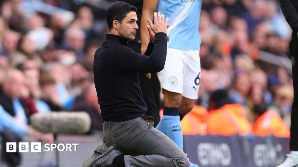 Mikel Arteta kneeling in despair on the touchline during Arsenal's defeat