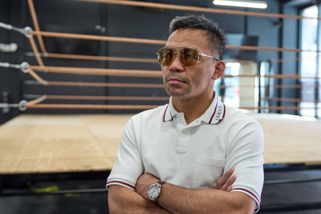 Manny Pacquiao and Floyd Mayweather facing off in the boxing ring