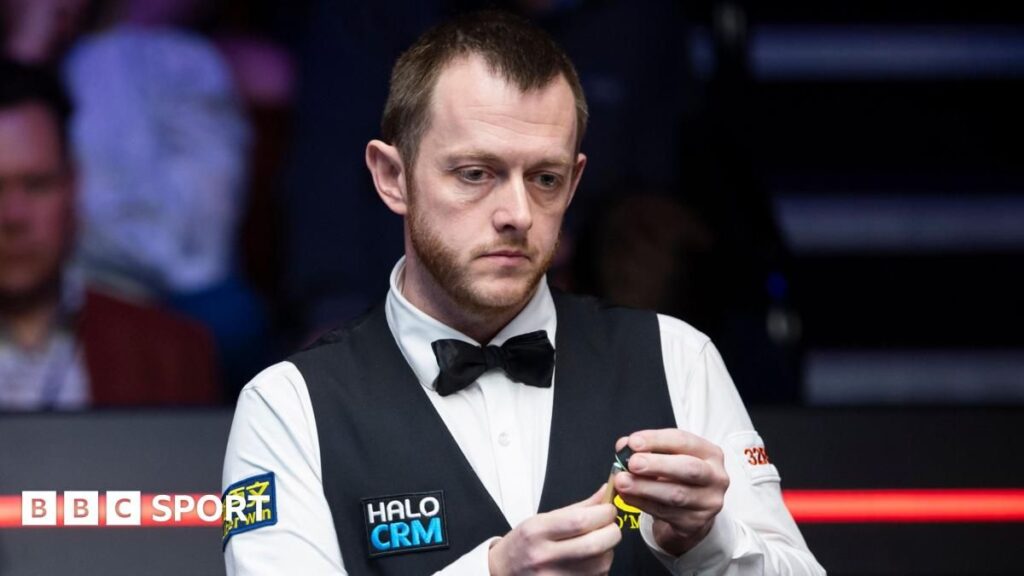 Mark Allen playing a shot at the table during the World Snooker Championship at the Crucible Theatre