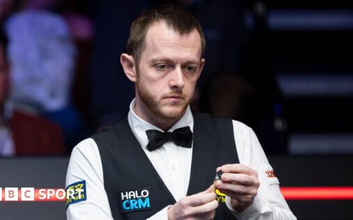 Mark Allen playing a shot at the table during the World Snooker Championship at the Crucible Theatre