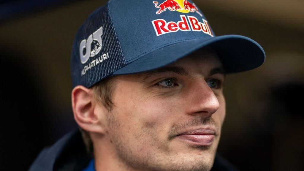 Red Bull driver Max Verstappen looking thoughtful while walking through the paddock at a Formula 1 Grand Prix