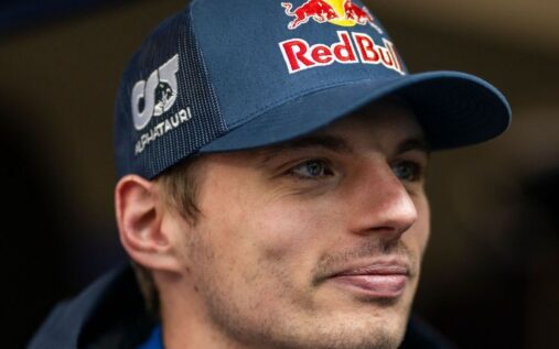 Red Bull driver Max Verstappen looking thoughtful while walking through the paddock at a Formula 1 Grand Prix