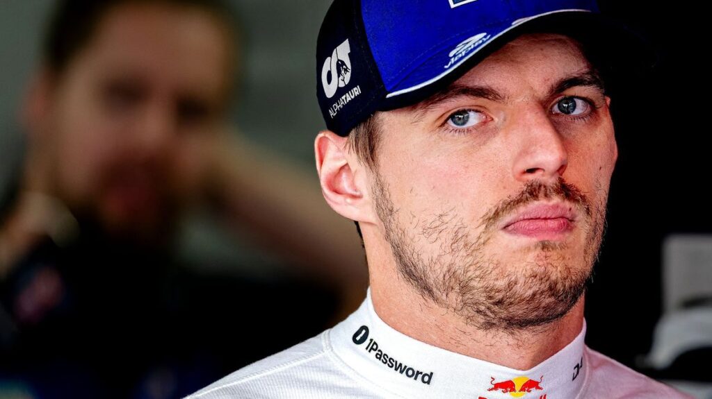 Max Verstappen looking thoughtful while wearing his Red Bull racing overalls