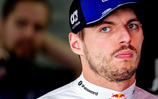 Max Verstappen looking thoughtful while wearing his Red Bull racing overalls