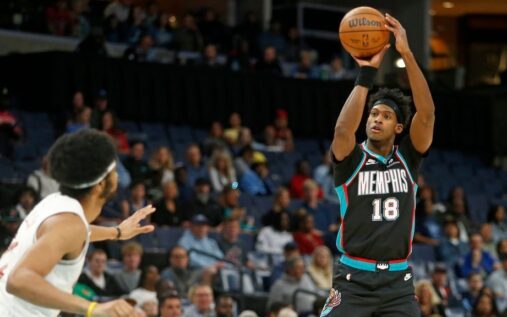 A Memphis Grizzlies player shooting a three-pointer during their NBA game against the Cleveland Cavaliers