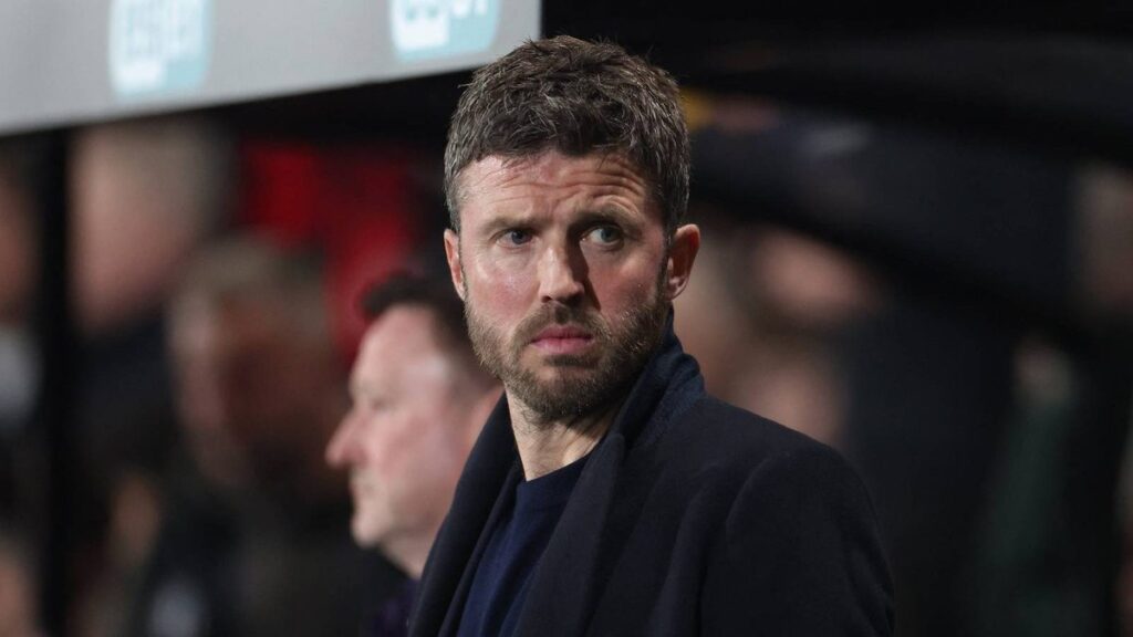 Michael Carrick standing on the touchline managing Manchester United