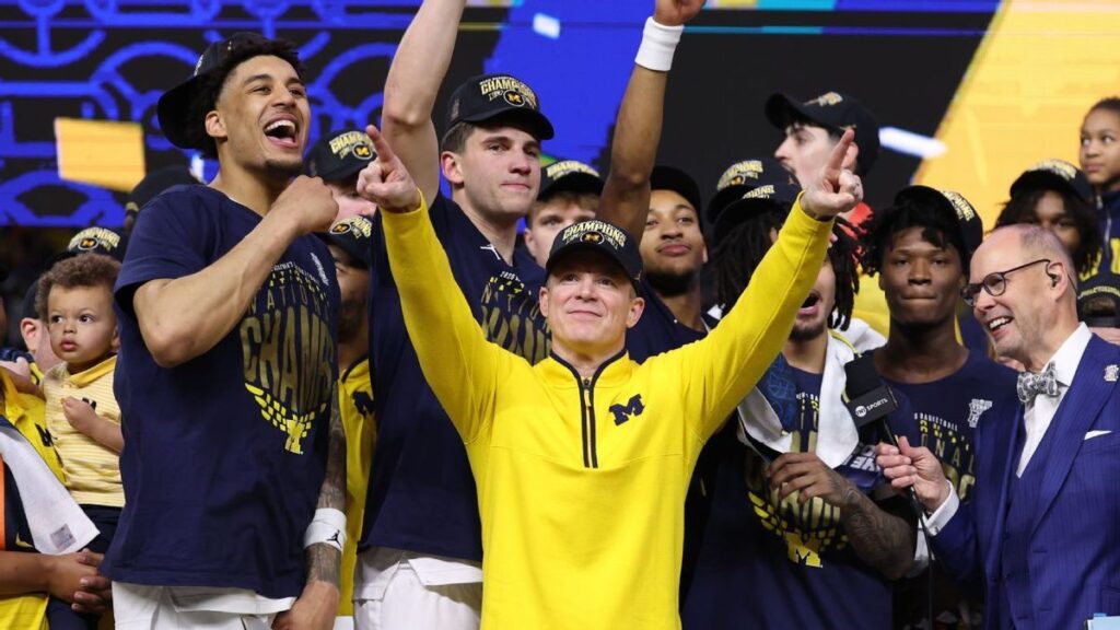 Michigan head coach Dusty May celebrating with his family after winning the NCAA national championship against UConn.
