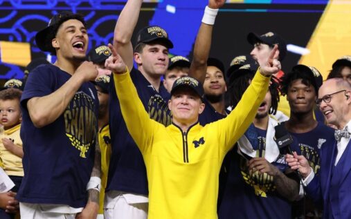 Michigan head coach Dusty May celebrating with his family after winning the NCAA national championship against UConn.