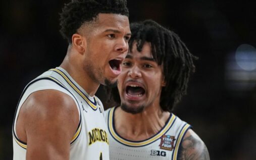 Michigan Wolverines players celebrating a victory during the NCAA college basketball tournament.
