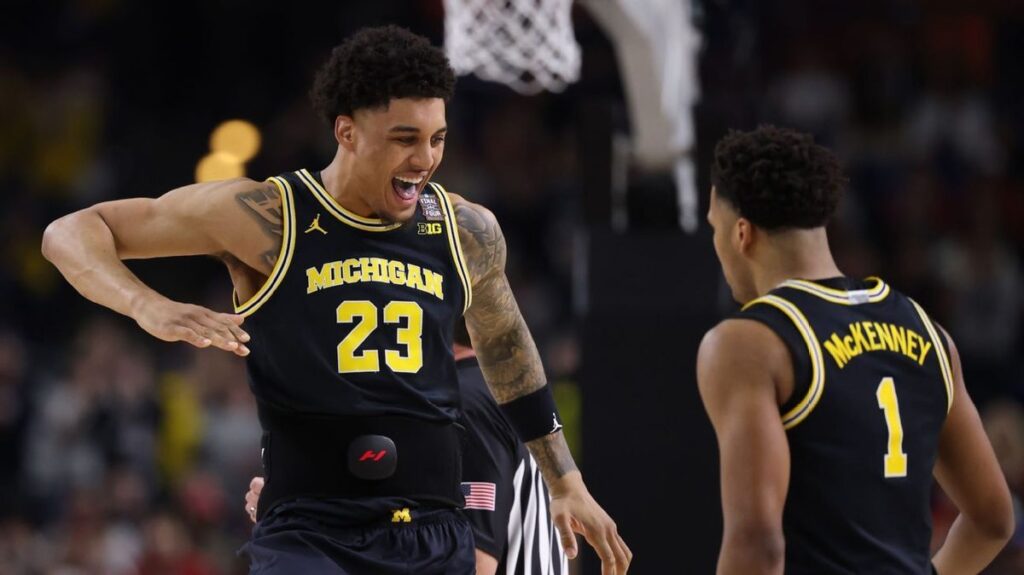 Michigan and UConn players competing on the basketball court during the NCAA championship